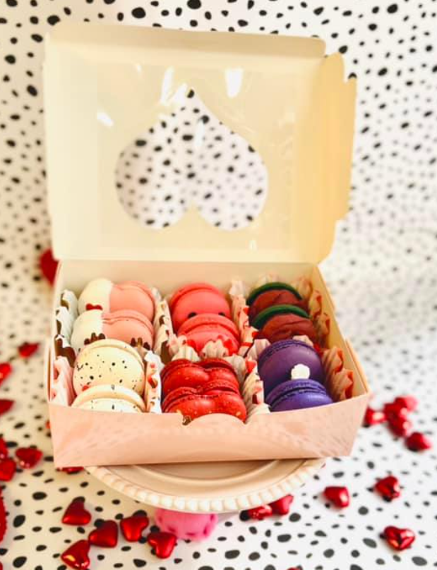 A specialty box of an assortment of Valentine-themed macarons